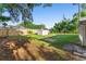 Large backyard featuring a shed, a privacy fence, and mature trees at 1550 Maxwell Ln, Deltona, FL 32738