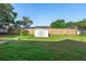 Spacious backyard featuring lush green grass, a shed, and a privacy fence at 1550 Maxwell Ln, Deltona, FL 32738