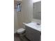 Bathroom featuring a tiled shower, modern gray vanity, and neutral decor at 1550 Maxwell Ln, Deltona, FL 32738
