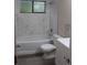 Bright bathroom with a marble-look tiled walls, a bathtub, shower, and modern vanity at 1550 Maxwell Ln, Deltona, FL 32738