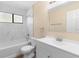 Bright bathroom featuring white marble tile surround, shower-tub combo, and modern vanity at 1550 Maxwell Ln, Deltona, FL 32738