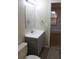 Well-lit bathroom with gray vanity, updated fixtures, and tile flooring at 1550 Maxwell Ln, Deltona, FL 32738
