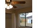 Bedroom features a ceiling fan, carpet, closet, and window with a backyard view at 1550 Maxwell Ln, Deltona, FL 32738