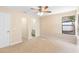 Light-filled bedroom features ceiling fan, closet and adjacent bathroom at 1550 Maxwell Ln, Deltona, FL 32738