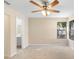 Sun-filled bedroom includes ceiling fan, neutral carpet and attached bathroom at 1550 Maxwell Ln, Deltona, FL 32738