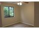 Bright bedroom featuring plush carpet, a ceiling fan, and a large window for natural light at 1550 Maxwell Ln, Deltona, FL 32738
