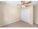 This bedroom has neutral color palette, ceiling fan, and double door closet at 1550 Maxwell Ln, Deltona, FL 32738
