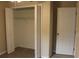 Spacious closet features bifold doors, shelving, and easy access from bedroom at 1550 Maxwell Ln, Deltona, FL 32738