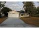 Charming single Gathering home with a well-maintained lawn and attached two-car garage at 1550 Maxwell Ln, Deltona, FL 32738