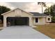 Exterior view of the home's garage, driveway, and bay window at 1550 Maxwell Ln, Deltona, FL 32738