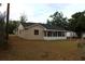 A charming home with a large yard and an enclosed sunroom at 1550 Maxwell Ln, Deltona, FL 32738