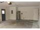 Unfinished garage with a hot water heater and ample storage space at 1550 Maxwell Ln, Deltona, FL 32738