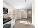 Bright kitchen adjacent to dining area boasts stainless appliances and wood-look flooring at 1550 Maxwell Ln, Deltona, FL 32738