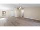 Open-concept living area with wood-look floors and an abundance of natural light at 1550 Maxwell Ln, Deltona, FL 32738