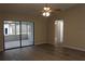 Spacious living room with ceiling fan and sliding glass doors to the screened patio at 1550 Maxwell Ln, Deltona, FL 32738