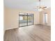 Bright living room showcasing neutral paint, wood-look floors, and access to other rooms at 1550 Maxwell Ln, Deltona, FL 32738