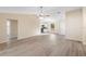 Open-concept living room with views of the kitchen, dining, and front entryway at 1550 Maxwell Ln, Deltona, FL 32738