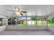 Enclosed sunroom with tiled floor, ceiling fan, and multiple windows overlooking the backyard at 1550 Maxwell Ln, Deltona, FL 32738