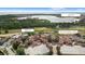 Aerial view of Bella Collina showcasing the pool, Club, Lake Siena, golf course, and tennis courts at 16124 Volterra Pt, Montverde, FL 34756