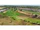 Panoramic aerial view of a pristine golf course community showcasing lush fairways and luxury homes at 16124 Volterra Pt, Montverde, FL 34756