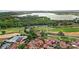 Panoramic aerial view showcasing a golf course, community pool, and the luxury residences near Lake Siena at 16124 Volterra Pt, Montverde, FL 34756
