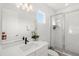 Modern bathroom featuring subway tile, glass enclosed shower, floating vanity with a sleek black faucet, and modern lighting at 16124 Volterra Pt, Montverde, FL 34756