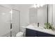 Modern bathroom featuring a glass door shower and navy blue vanity at 16124 Volterra Pt, Montverde, FL 34756