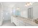 Modern bathroom with a double vanity, sleek fixtures, and a glass-enclosed shower at 16124 Volterra Pt, Montverde, FL 34756