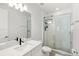 Modern bathroom features subway tile, glass enclosed shower, vanity with a sleek black faucet, and modern lighting at 16124 Volterra Pt, Montverde, FL 34756