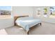 Airy bedroom featuring large windows that let in natural light and a wooden bed frame at 16124 Volterra Pt, Montverde, FL 34756