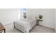 Cozy bedroom featuring neutral tones, a queen-size bed, and stylish side tables at 16124 Volterra Pt, Montverde, FL 34756