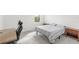 Spacious bedroom featuring a minimalist bed frame, two nightstands, and a modern office setup for a comfortable living space at 16124 Volterra Pt, Montverde, FL 34756