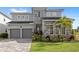 Beautiful two-story home featuring a two-car garage, stone accents, and a meticulously manicured lawn at 16124 Volterra Pt, Montverde, FL 34756