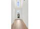 Bright foyer with high ceilings, wood floors, and a clear view to the front door with sidelights at 16124 Volterra Pt, Montverde, FL 34756