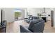 Bright open living area with modern furnishings and seamless access to the kitchen and outdoor patio at 16124 Volterra Pt, Montverde, FL 34756
