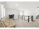 Open loft area with comfortable seating, a work area, and modern railing at 16124 Volterra Pt, Montverde, FL 34756