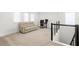 Bright loft area with comfortable seating, desk space, and modern black railing at 16124 Volterra Pt, Montverde, FL 34756