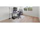 Bright home office space with wood flooring, filled with natural light from the window at 16124 Volterra Pt, Montverde, FL 34756