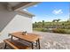 Covered patio featuring a picnic table with scenic views of the beautifully landscaped backyard and golf course at 16124 Volterra Pt, Montverde, FL 34756