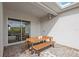 Covered patio with wooden picnic table, ideal for outdoor dining and relaxation with easy access to the yard at 16124 Volterra Pt, Montverde, FL 34756