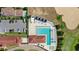 Overhead shot of a luxurious community pool surrounded by lounge chairs, cabanas, and ample parking at 16124 Volterra Pt, Montverde, FL 34756