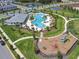 Aerial view of community pool, playground, and surrounding homes in a Primary-planned neighborhood at 16436 Parable Way, Winter Garden, FL 34787