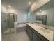 Modern bathroom featuring double sinks, a separate shower, and a luxurious soaking tub at 16436 Parable Way, Winter Garden, FL 34787