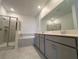 The bathroom features a double vanity, a walk-in shower and a soaking tub with tile surround at 16436 Parable Way, Winter Garden, FL 34787