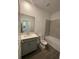 Bathroom with tiled shower, tub, gray vanity with light countertop, sink, and toilet at 16436 Parable Way, Winter Garden, FL 34787