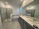Modern bathroom featuring double sinks, a separate shower, and a luxurious soaking tub at 16436 Parable Way, Winter Garden, FL 34787