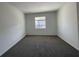 The bedroom showcases neutral carpeting and a window providing a light-filled space at 16436 Parable Way, Winter Garden, FL 34787