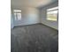 Spacious carpeted bedroom with two windows, allowing plenty of natural light into the room at 16436 Parable Way, Winter Garden, FL 34787