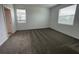 Comfortable bedroom with plush carpeting and ample natural light from the two windows at 16436 Parable Way, Winter Garden, FL 34787