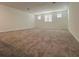 The bonus room features a neutral color palette, carpeting, and three windows at 16436 Parable Way, Winter Garden, FL 34787